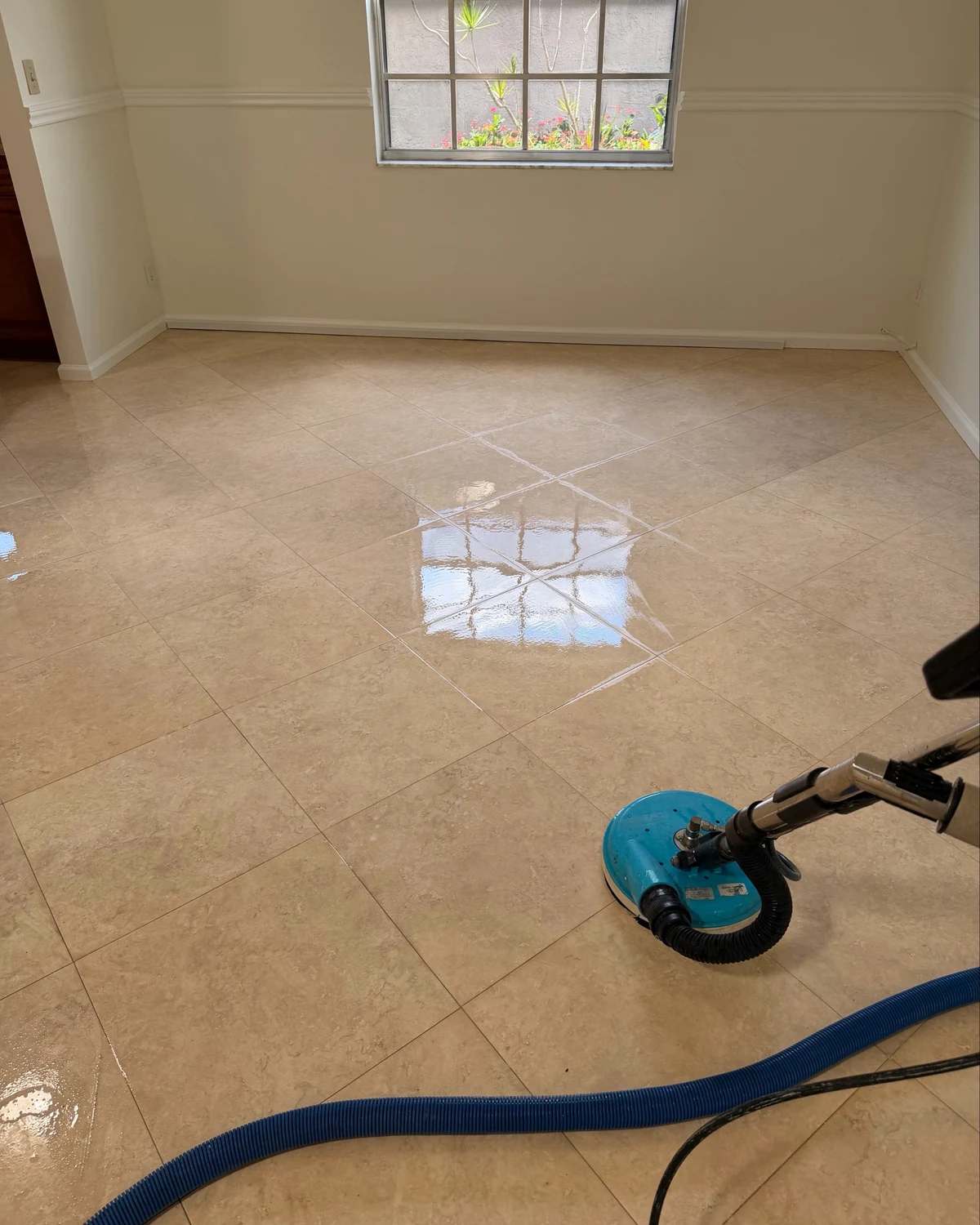 Professional rotary tile-cleaning equipment working across a South Florida tile floor